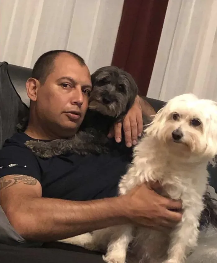 Javier Paredes mit zwei Hunden auf dem Sofa